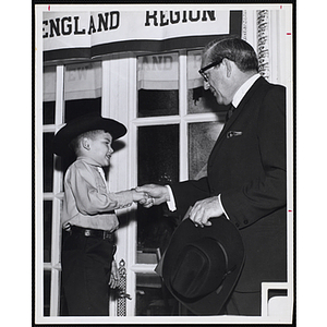 Semon Knudsen, president of Ford Motor Corporation, shakes Bunker Hillbilly Billy Porthier's hand during the BCA New England Board Conference at the Sheraton Plaza