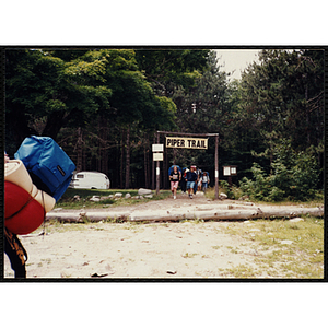 A group of youth with backpacks exit the Piper Trail