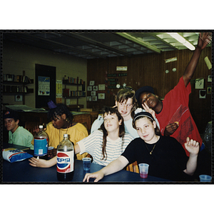 Children sit at a table with snacks at the Tri-Club youth leadership event at the Roxbury Clubhouse