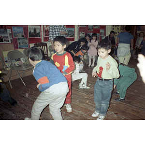 Children scramble to retrieve candy from a piñata at Chinese Progressive Association's celebration of the Lunar New Year