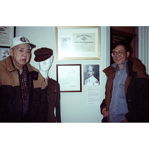 Chinese Progressive Association members walking in front of a wall with veterans' honors