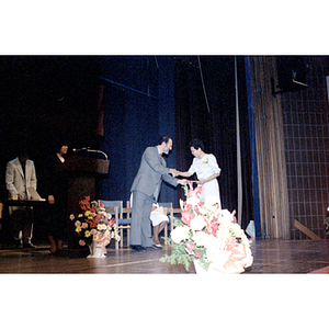 Diploma presentation to Lai Lia Cam at Roxbury Community College's commencement ceremony