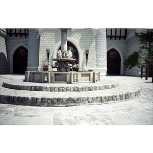 Ornate fountain in front of a medieval-style building