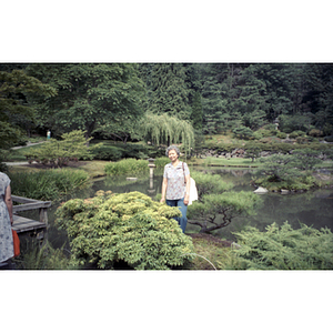 Woman poses in front of a pond