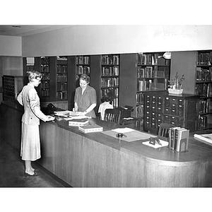 Woman checking books out at Dodge Library's Circulation Desk