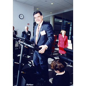 Roger Marino demonstrates the use of a StairMaster at the dedication ceremony for the Marino Recreation Center