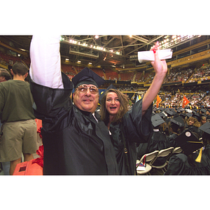 Graduates waving during commencement ceremony