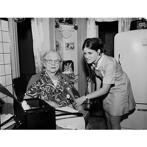 A female co-op nursing student takes the blood pressure of a patient