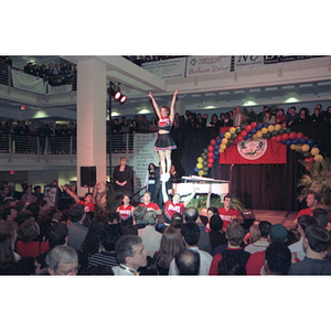 A cheerleader is held up in the air during President Freeland's First Night celebration