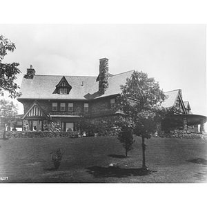 Exterior of Henderson House including a large yard and trees