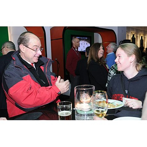 President Aoun speaking with a student at the reception during the Beanpot