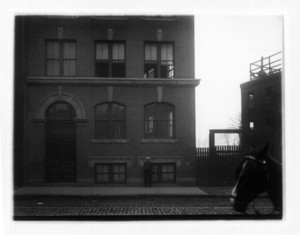 View of the corner of a building, probably on Dorchester Ave., with a horse on the left side