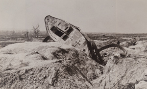 Overturned German tank in a war-torn field