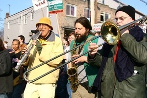 Brass band playing among anti-war marchers: rally and march against the Iraq War
