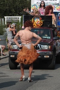 Parade marcher in dress with a furry hem : Provincetown Carnival parade