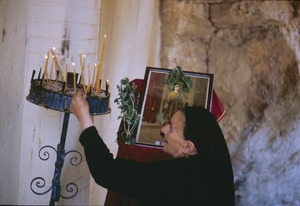 Widow lighting candles at Ohrid monastery