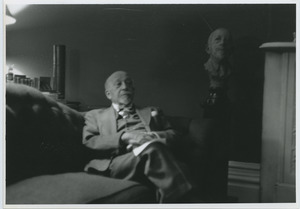 W. E. B. Du Bois sitting on the couch in his Brooklyn home