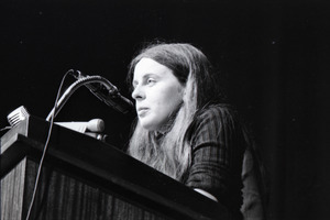 Bernadette Devlin McAliskey at the podium during a talk at Northeastern University