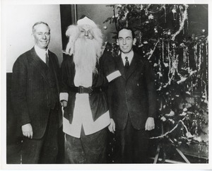 Two unidentified men and a client dressed as Santa Claus