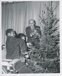 Dr. DiMichael decorating Christmas tree with clients