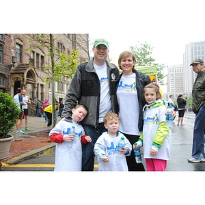 A family in Boston Strong #OneRun t-shirts pose for a photo near Old South Church