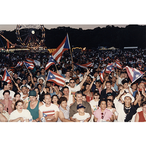 A large crowd waving Puerto Rican flags at the Festival Puertorriqueño