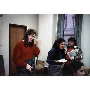 Clara Garcia and other staff members laughing during an office party.