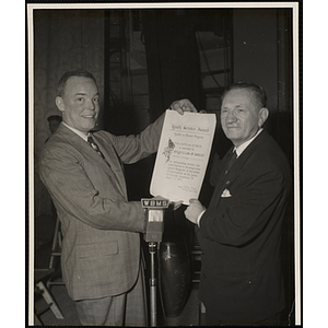 "Mr. Loren C. White, Overseer of the Boys' Clubs of Boston and Chairman of the Bunker Hill Clubhouse Committee, receiving Youth Service Award Certificate of Merit presented to the Boys' Clubs of Boston by Dr. Dolphe Martin on the Youth on Parade Program over radio station WBMS, April 27, 1957"