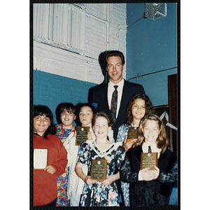 Former Boston Celtic Dave Cowens posing for a group picture with six girls at a Kiwanis Awards Night