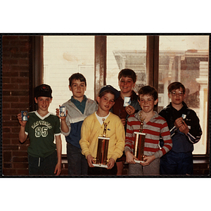 Six boys posing with their awards at a Boys' Club awards event