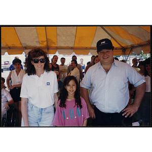 A girl poses for a shot with a woman and man during the Bunker Hill Road Race