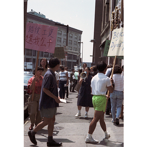 Protesters stand outside Dynasty Restaurant picketing for workers' back wages