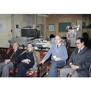 Henry Wong, You King Yee, and another member of the Chinese Progressive Association sit with the Consulate General (of the People's Republic of China) at the organization's office in Boston
