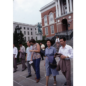 Visitors from China walk down the steps of the Massachusetts State House