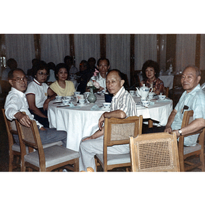 Men and women sit around a table during an Association trip to China