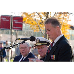 A man reads from notes at the Veterans Memorial dedication ceremony