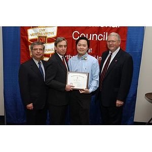 New inductee Victor Tong poses with his certificate and three others at the National Council Dinner