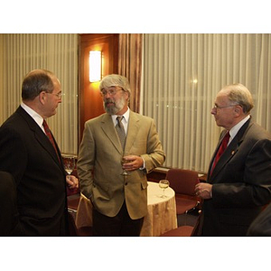 Robert E. DiCenso (CBA '62), left, and guests conversing at the College of Business Administration's Distinguished Service Awards ceremony