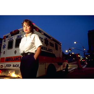 EMT intern, Jennifer Joy, stands beside an ambulance