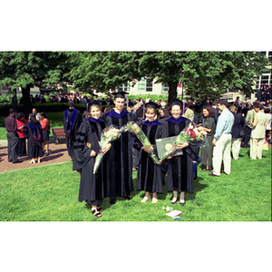 School of Law graduates holding flowers at commencement