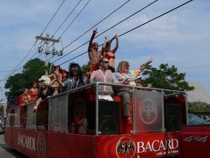 Bacardi rum float, wirth Bruce Vilanch (tie dye shirt) in the Provincetown Carnival parade