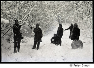 Communards trudging through the snow at Packer Corners with sleds
