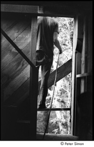 James Taylor's house: Taylor standing in window of his under construction house