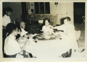 Shirley Graham Du Bois and W. E. B. Du Bois dining with three unidentified individuals