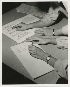 Two pairs on hands on a table demonstrating left-hand writing instruction