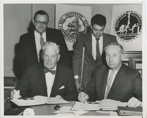 Presidents Bruce Barton of ICD and Carroll V. Newsom of NYU signing an affiliation agreement