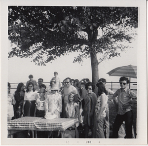 Group poses behind picnic table