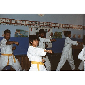 Four Latino students performing a karate demonstration in a classroom at the Festival Betances, Boston, 1986