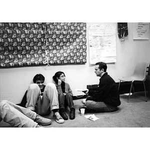 Inquilinos Boricuas en Acción staff member Erik Blanchard sitting on the floor with several teens during a Teen and Kid Empowerment Program class.