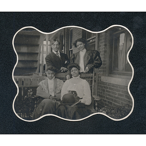 Family portrait, four individuals pose for a photograph